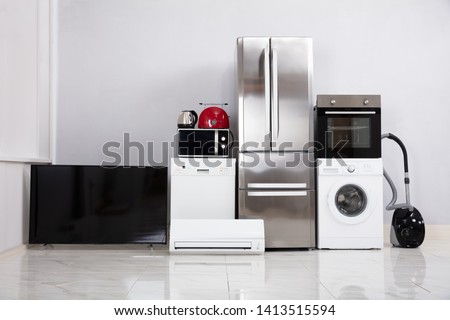 Set Of Modern Appliances On Reflective White Floor In The New Kitchen Apartment