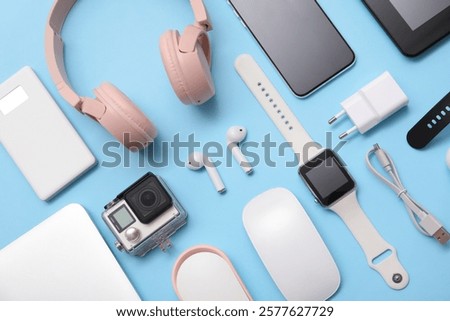Set of modern devices on blue background, top view