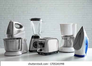 Set of modern home appliances on white table - Shutterstock ID 1705241998