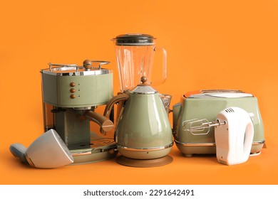 Set of modern household appliances on orange background - Shutterstock ID 2291642491