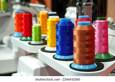 set of multi colored threads of modern electronic professional embroidery machine, Selective focus.	                           