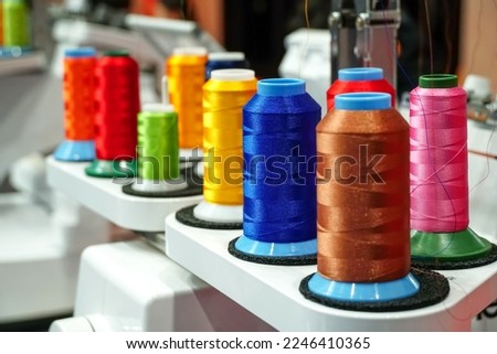 set of multi colored threads of modern electronic professional embroidery machine, Selective focus.	                           