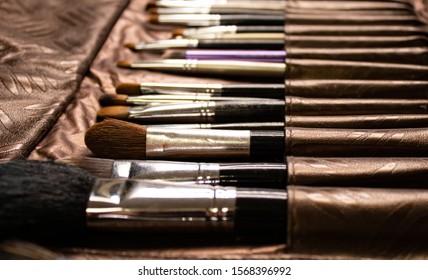 Set Of Multi-size Makeup Artist Brushes Laying In A Line In A Professional Bag