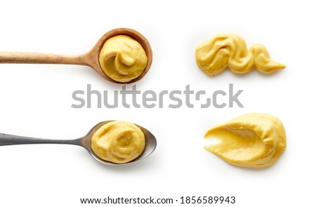 Set of mustard in spoons isolated on white background top view
