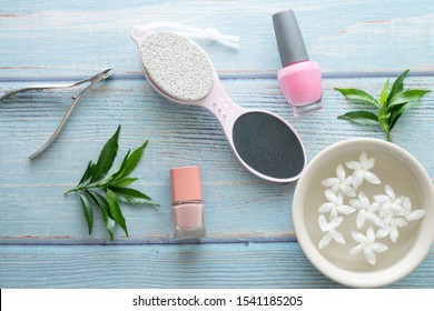 A Set Of Nail Tools For Manicure And Pedicure On A Blue Wooden Background. Gel Polishes, Nail Files Top View.