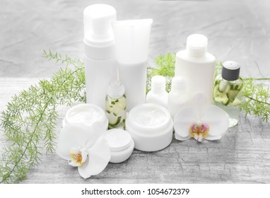 Set Of Natural Cosmetics With Herbal Extract On Grey Table