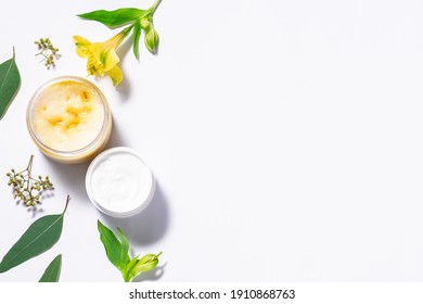 Set of natural herbal cosmetic on white background with flowers and leaves.