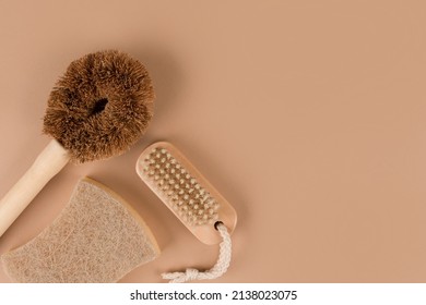 Set Of Natural Household Cleaning Products - Bamboo Brushes And Organic Dishcloth On Beige Background With Copy Space. Green Cleaning Concept