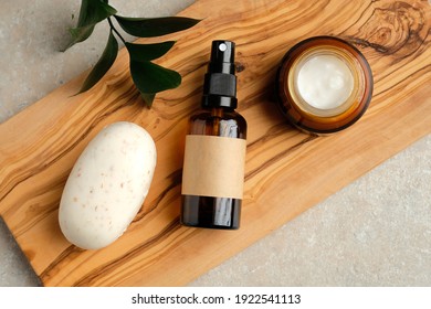 Set Of Natural Organic SPA Beauty Products On Wooden Board. Homemade Soap, Moisturizer Cream Jar, Amber Glass Spray Bottle, Green Leaf On Wooden Board.