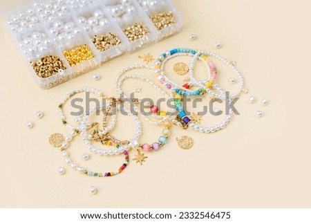 Set of for needlework and beading. Handmade pearls beaded jewelry and different beads in boxes. DIY art activity. Creativity and  hobby.