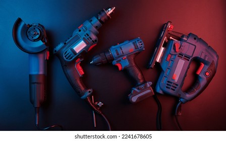 Set of new power tools isolated on a black background, drill, puncher, electric saw, jigsaw, circular saw - Shutterstock ID 2241678605