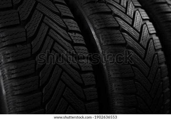 Set of new\
winter tires as background,\
closeup