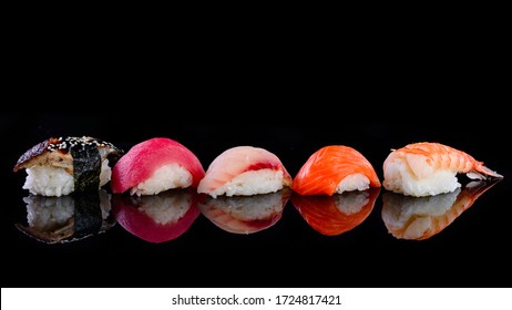 set nigiri on a black. Eel, salmon and tuna sushi with chopsticks, dark background - Powered by Shutterstock