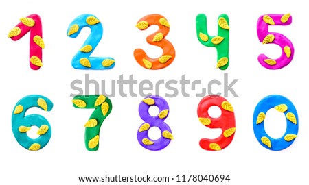 A set of numbers from 0 to 9 of colorful children's plasticine with yellow autumn leaves isolate on white background