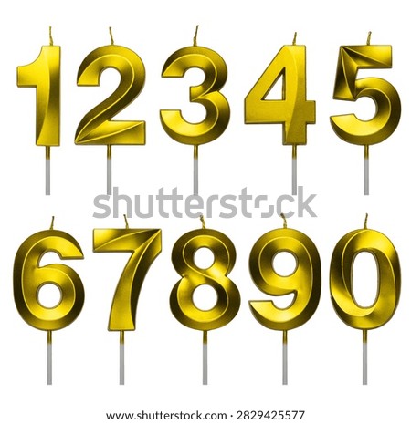 Set of numbers from one to zero shaped golden metallic birthday candles isolated on a white background