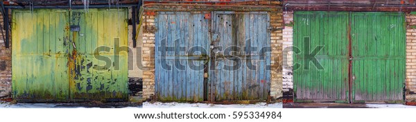 Set of obsolete worn out wear old fashion car garage\
wooden gates background abstract pattern texture. Antique\
automobile old wooden gates in winter. Damaged painting wood,\
rusted gates set