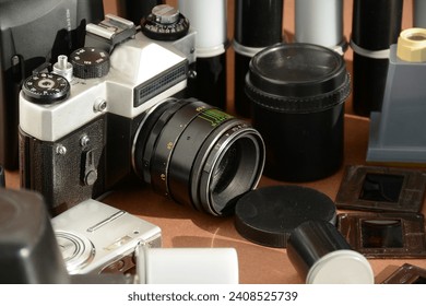 A set of old cameras, lenses, films, slides. Retro