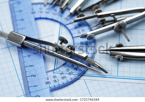 Set\
of old drawing tools on background with graph\
paper