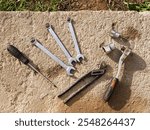 A set of old tools: wrenches, ratchet, screwdrivers, pliers, cap wrenches on a concrete surface background. Automotive repair, mechanics, car restoration, work and industry