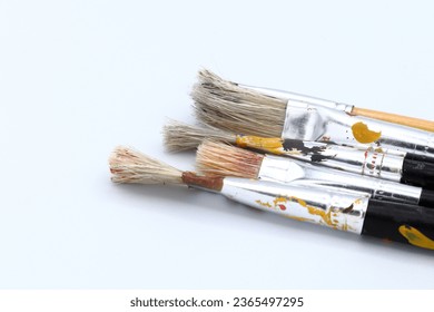 A set of old used paint brushes. With a white background. - Shutterstock ID 2365497295