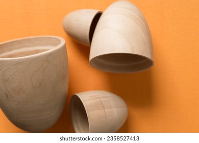 set of open wooden crafting ovoid objects on orange paper
