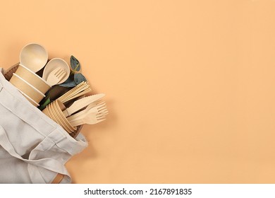 A set of organic food in an eco-bag on a pastel table. Paper cups, plates, kraft paper napkins, barbecue straws, wooden forks, spoons and knives, mockup, healthy lifestyle concept, zero waste - Shutterstock ID 2167891835
