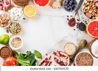 Set of organic healthy diet food, superfoods - beans, legumes, nuts, seeds, greens, fruit and vegetables.. white background copy space. top view frame