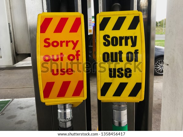 A set of out of order petrol and diesel
gas vehicle car and truck fuel pumps with a cover sign that reads

