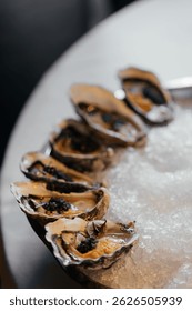 A set of oysters with additional stuffing inside. Sophisticated decor in a restaurant.