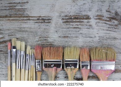 Set of paintbrushes in a wood background, vintage