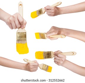 set of painter hands with flat paint brushes with yellow painted tips isolated on white background