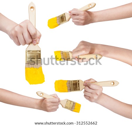 set of painter hands with flat paint brushes with yellow painted tips isolated on white background