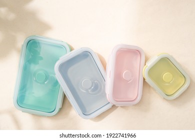 A Set Of Pastel Reusable And Foldable Silicone Lunch Box And Food Container On The Table With Sunlight Shine On. Reduce Waste, Better World, Zero Waste Campaign. Top View Close Up With Copy Space.