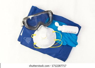 A set of Personal protection equipment against respiratory viral infections. Protective glasses , disposable gloves, suit and an antiseptic prevent the spread of infection . CoronaVirus Cavid-19