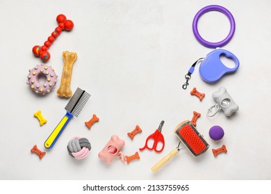 Set of pet care accessories and snacks on light background