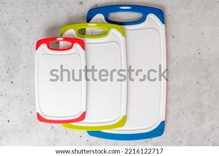 Set of plastic cutting boards in different colors and sizes close-up, copy space