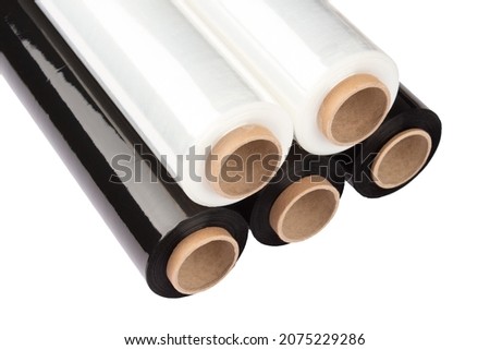 Set of plastic packaging materials - plastic white and black stretch film rolls isolated on white. PE packaging materials. Selective focus