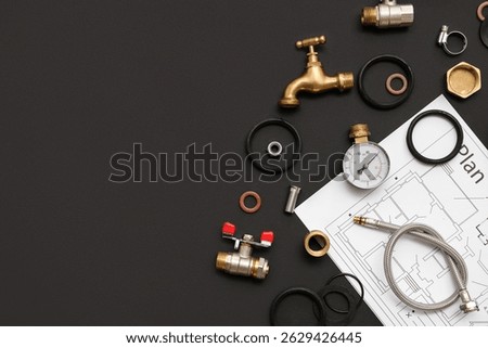 Set of plumber's items with house plan on black background