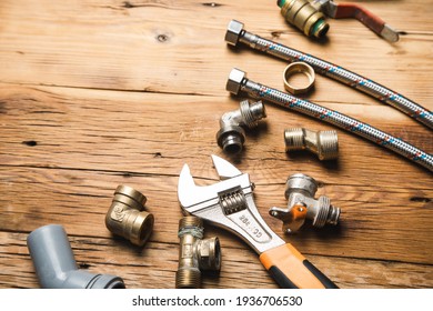 Set of plumbing and tools on the wooden background