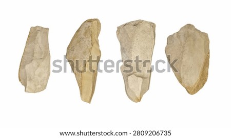 Set of prehistoric flint stone tools isolated on white background, four ancient chipped rock artifacts and hand axe blades, archaeology museum, Stone Age technology and history concept, no people