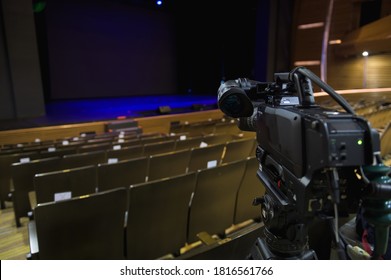 Set Up And Preparation Video Camera Before The Event At Stage Theater Or Concert Hall For Professional Photographer Filming Video Or Television Broadcasts With Empty Stage On Background  