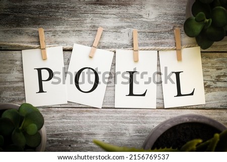 A set of printed cards spelling the word POLL on an aged wooden background.