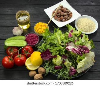 Set of products for healthy nutritio .Cooking of vegetables and herbs for cooking lunch. Sesame seeds, lemon and corn for salad.