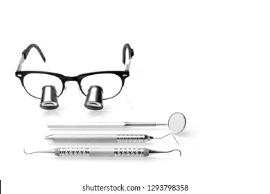 Set Of Professional Dentist Tools And Surgical Loupe Isolated On White Background In Dental Office. Dental Hygiene And Health Conceptual Image.