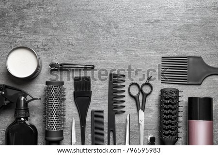 Set of professional hairdresser tools on light grey background