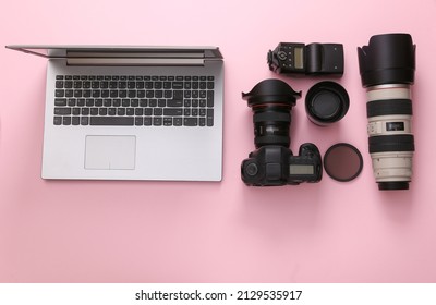 Set of professional photographic equipment (camera with lenses) with laptop on a pink background. Top view. Flat lay - Powered by Shutterstock