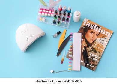 Set Of Professional Tools For Manicure, Nail Polishes And Magazine On Color Background