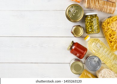 Set Of Raw Cereals, Grains, Pasta And Canned Food On A White Table. Copy Space. Flat Lay.