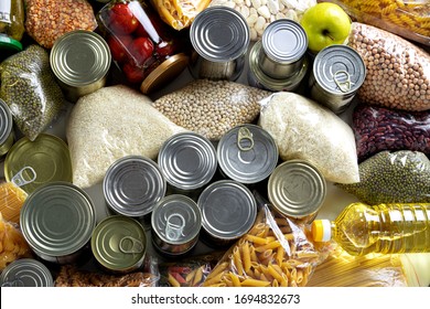 Set of raw cereals, grains, pasta and canned food on the table. - Shutterstock ID 1694832673