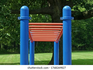 A set of red bars in an empty playground